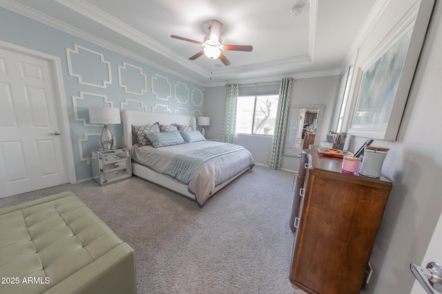 bedroom featuring carpet, a raised ceiling, crown molding, and baseboards