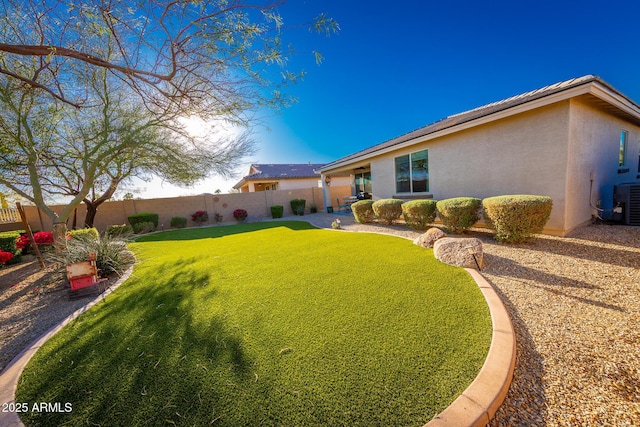 view of yard featuring a fenced backyard and central AC unit