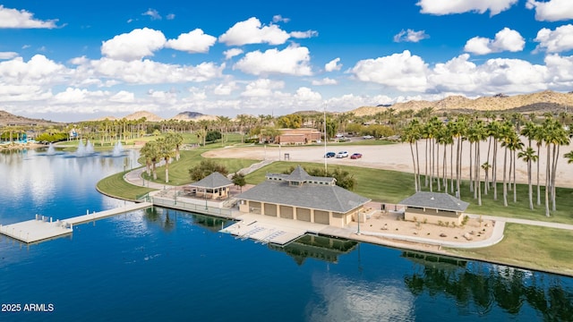 birds eye view of property with a water and mountain view