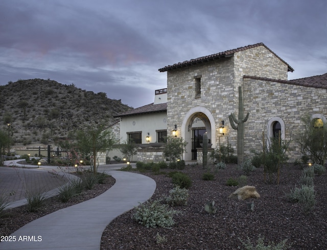 view of front of house with a tile roof and stucco siding