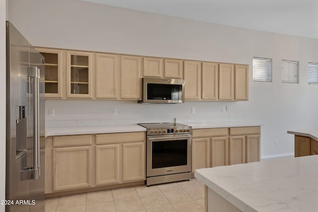 kitchen featuring light brown cabinets, appliances with stainless steel finishes, and light tile patterned flooring