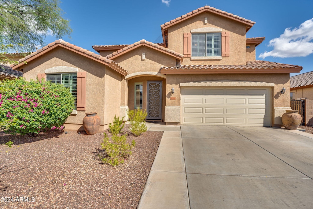 mediterranean / spanish-style home featuring a garage