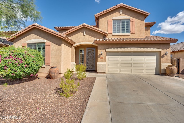 mediterranean / spanish-style home featuring a garage