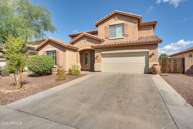 mediterranean / spanish-style home with a garage