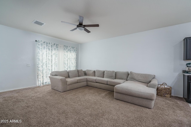 carpeted living room with ceiling fan