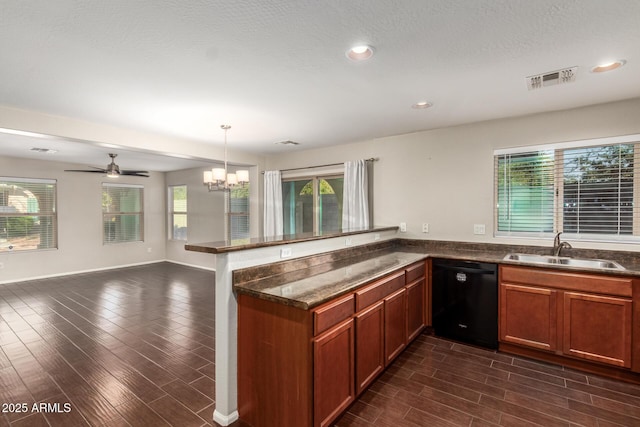 kitchen featuring dishwasher, wood finish floors, a sink, and a healthy amount of sunlight