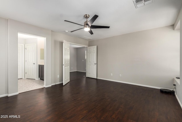 unfurnished bedroom with dark wood-style flooring, visible vents, and baseboards