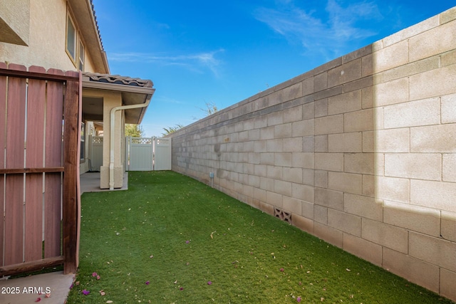 view of yard with a fenced backyard