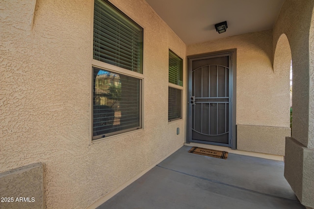 doorway to property with stucco siding