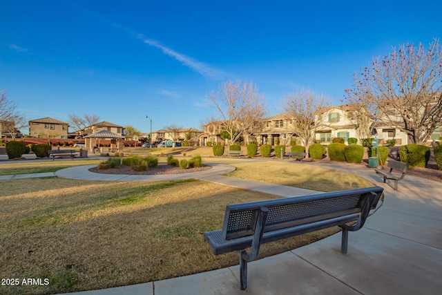 surrounding community with a residential view, a lawn, and a gazebo