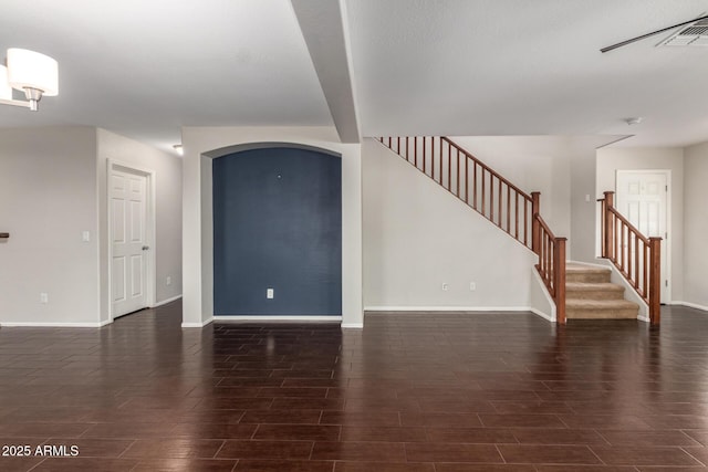 foyer entrance featuring wood tiled floor, stairway, and baseboards