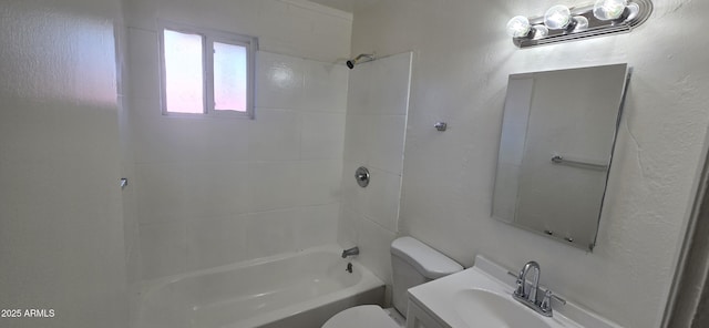 full bathroom featuring tiled shower / bath combo, toilet, and vanity