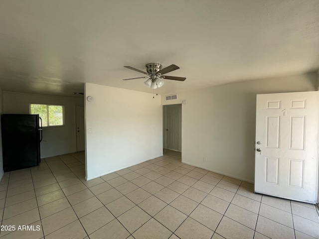 tiled empty room with ceiling fan