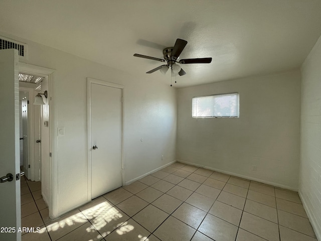 unfurnished bedroom featuring light tile patterned floors and ceiling fan