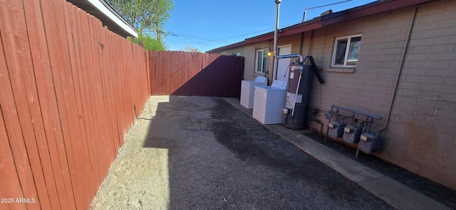 view of home's exterior featuring separate washer and dryer and water heater