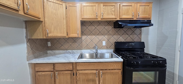 kitchen featuring backsplash, black gas stove, light stone countertops, and sink