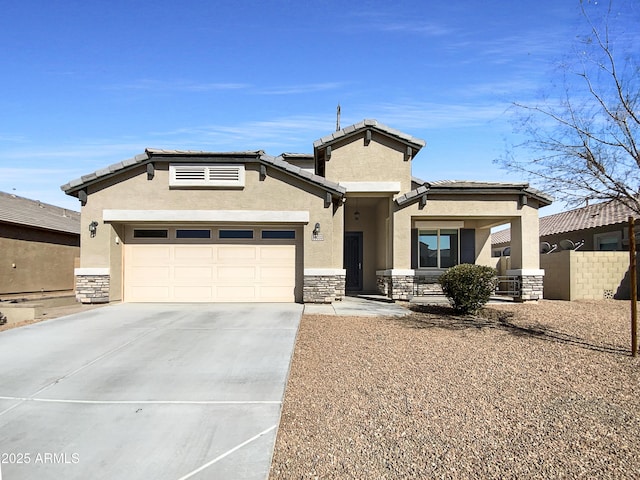 view of front facade with a garage, stone siding, concrete driveway, a tiled roof, and stucco siding