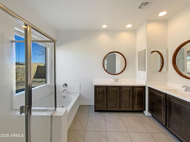 full bath with a bath, visible vents, a sink, and tile patterned floors