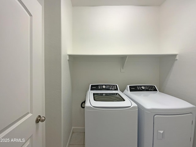 laundry area with laundry area, light tile patterned flooring, and independent washer and dryer