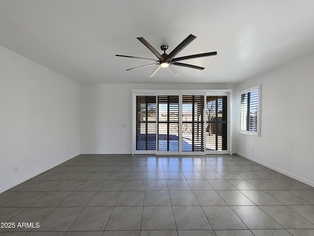 empty room with ceiling fan, baseboards, and tile patterned floors