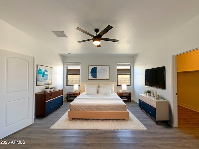 bedroom featuring multiple windows, dark wood finished floors, and visible vents