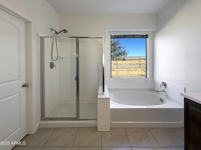 full bathroom with a bath, a stall shower, tile patterned flooring, and vanity