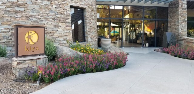 property entrance with stone siding