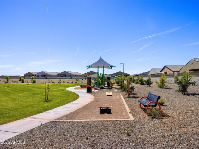communal playground with a yard and fence