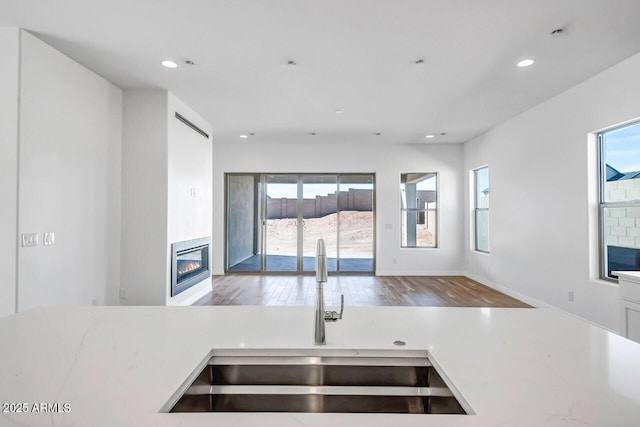 3310 Iron King Cir, Prescott, AZ 86301 - kitchen with a glass covered fireplace, recessed lighting, wood finished floors, a sink, and open floor plan