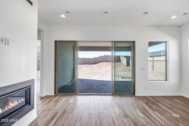 3310 Iron King Cir, Prescott, AZ 86301 - doorway with baseboards, plenty of natural light, a glass covered fireplace, and wood finished floors