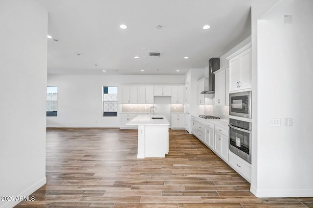 3310 Iron King Cir, Prescott, AZ 86301 - kitchen with wall chimney exhaust hood, stainless steel oven, black microwave, visible vents, and stovetop