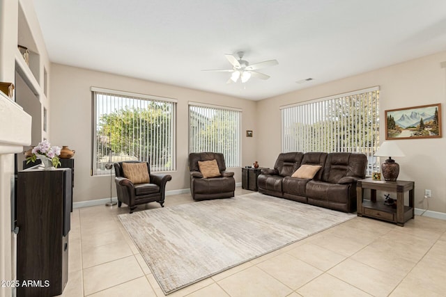 tiled living room featuring ceiling fan