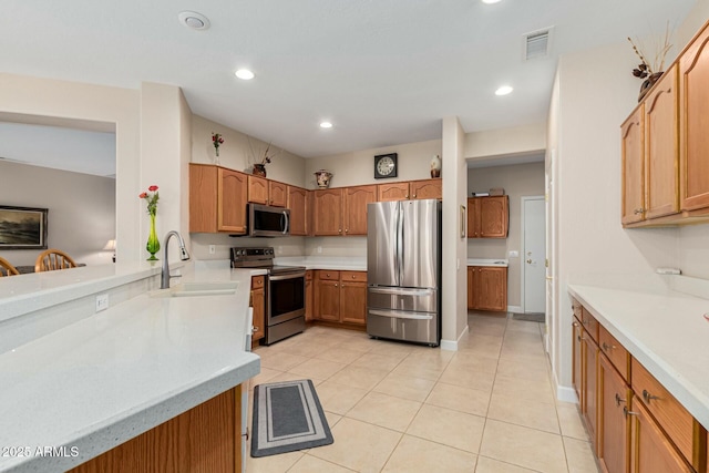 kitchen with light tile patterned flooring, stainless steel appliances, and sink