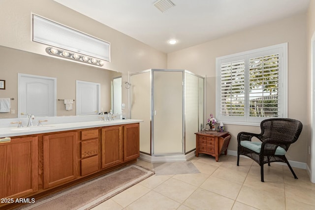 bathroom featuring tile patterned floors, a shower with shower door, and vanity