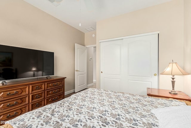 bedroom with lofted ceiling and a closet