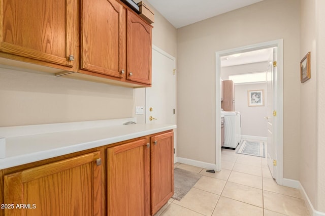 interior space featuring washing machine and dryer and light tile patterned floors