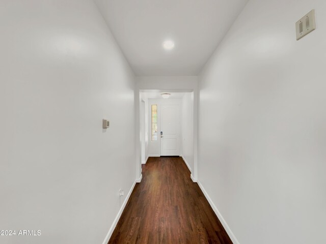 hallway with dark wood-type flooring