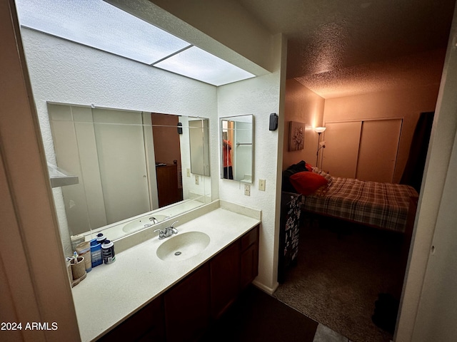 bathroom with vanity and a textured ceiling