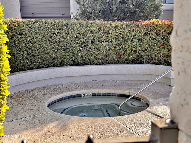 view of swimming pool featuring an in ground hot tub