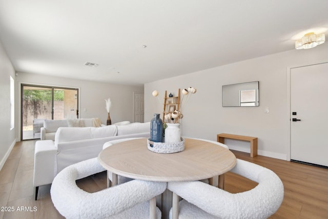 7500 E Deer Valley Rd Unit 132, Scottsdale, AZ 85255 - dining area featuring light wood-type flooring and baseboards