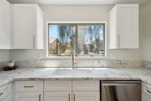 7500 E Deer Valley Rd Unit 132, Scottsdale, AZ 85255 - kitchen with dishwasher, white cabinetry, light stone countertops, and a sink