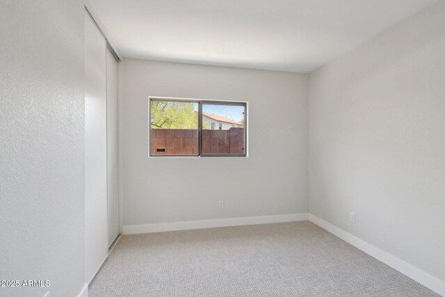 7500 E Deer Valley Rd Unit 132, Scottsdale, AZ 85255 - empty room featuring light carpet and baseboards