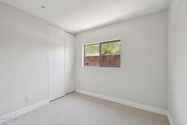 7500 E Deer Valley Rd Unit 132, Scottsdale, AZ 85255 - spare room featuring light carpet and baseboards