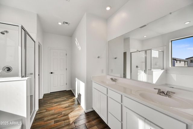 7423 W Cavalier Dr, Glendale, AZ 85303 - full bathroom with a stall shower, wood finished floors, recessed lighting, and double vanity