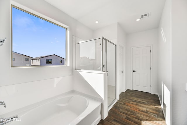 7423 W Cavalier Dr, Glendale, AZ 85303 - bathroom featuring a stall shower, a garden tub, wood finished floors, and recessed lighting