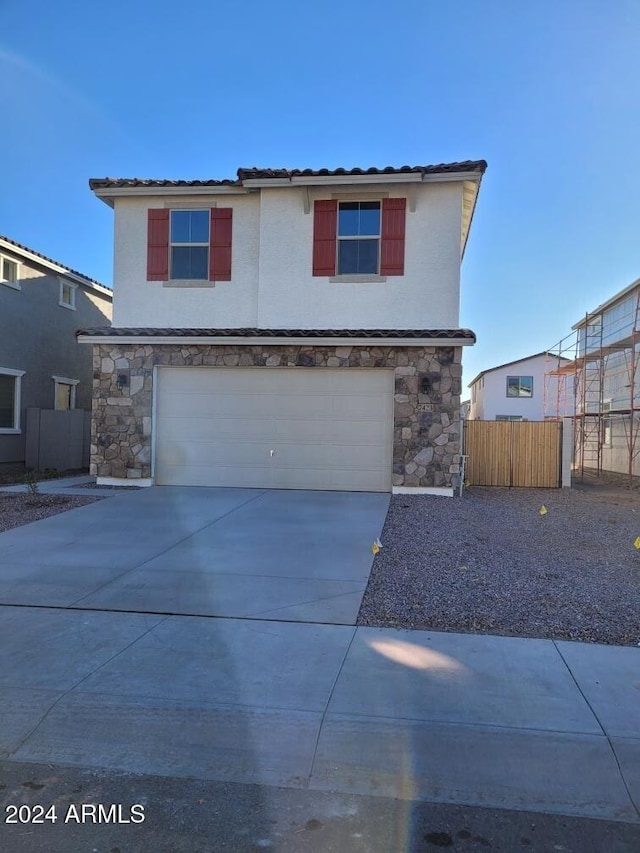 7423 W Cavalier Dr, Glendale, AZ 85303 - traditional home featuring fence, stone siding, an attached garage, concrete driveway, and stucco siding
