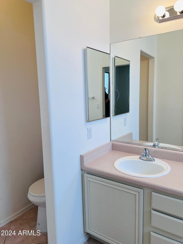 bathroom featuring vanity, toilet, and tile patterned floors