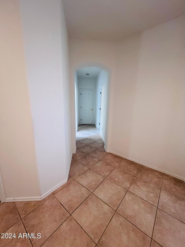 hall featuring light tile patterned flooring