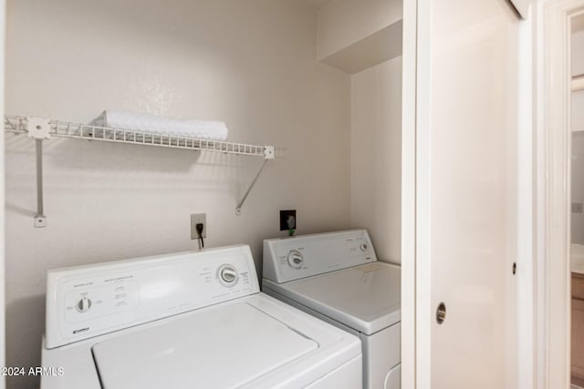 washroom with washing machine and dryer and laundry area