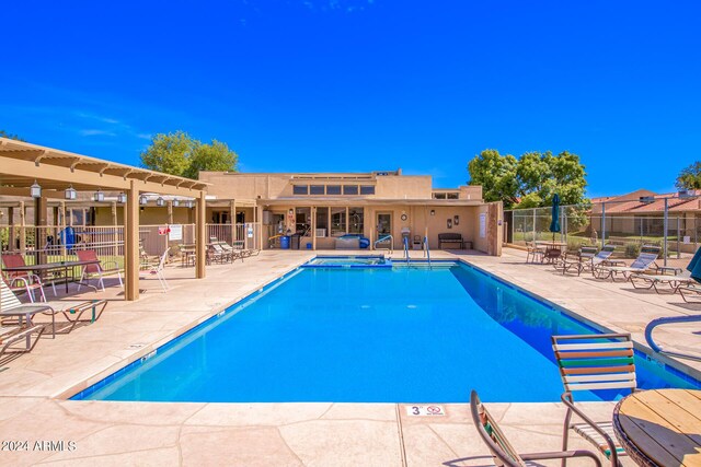 pool with fence and a patio